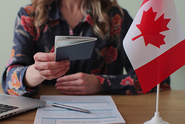 canadian woman consular officer giving passport male immigrant work visa citizenship visa application online form immigration concept visa approval
