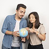 man woman posing with globe white