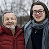 portrait smiling grandfather grandson standing outdoors